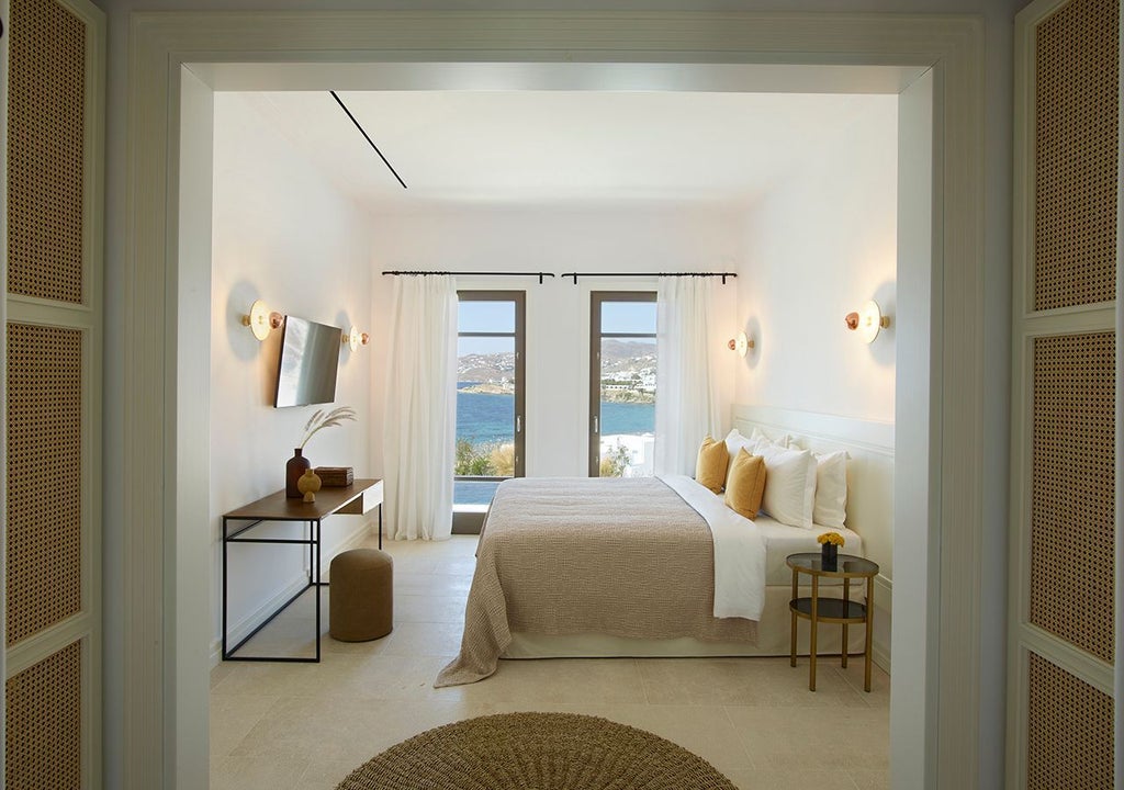 Luxurious two-bedroom home in Mykonos with panoramic Aegean Sea view, private heated pool, and contemporary Mediterranean design.