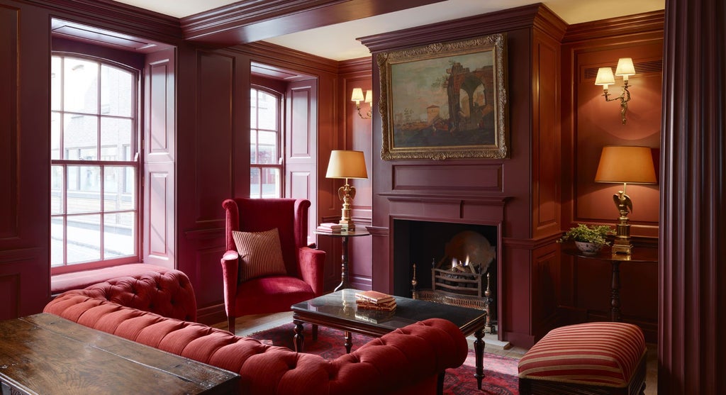 Elegant 18th-century boutique hotel room with ornate Georgian-inspired decor, plush furnishings, and rich jewel-toned color palette in a historic UK setting