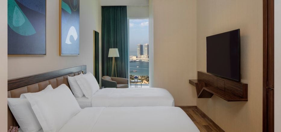 Luxurious two-bedroom sea view apartment at scenset+ Palm View Dubai Hotel, featuring modern decor, spacious layout, and panoramic cityscape windows