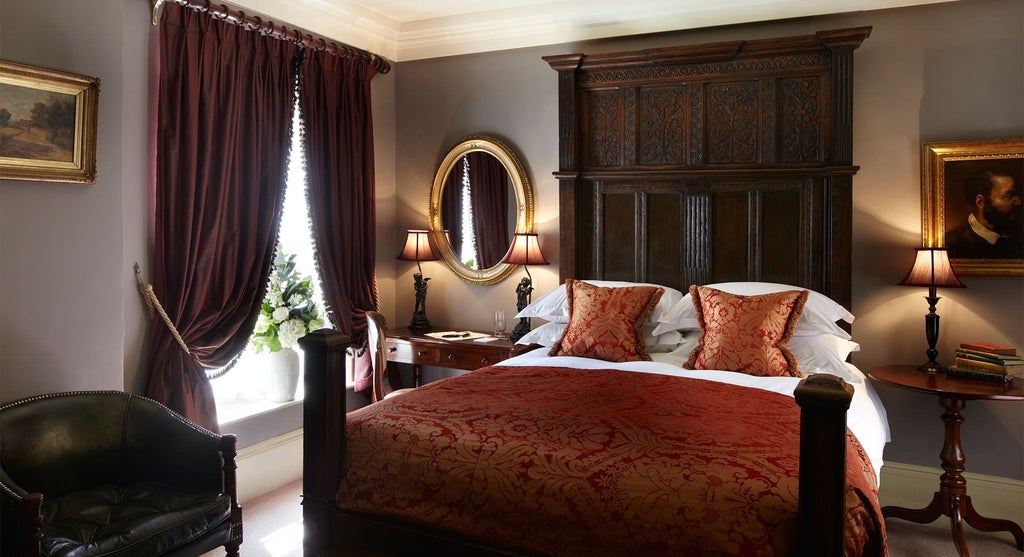 Elegant club double room featuring plush bedding, sophisticated dark wood furnishings, warm lighting, and refined British hospitality design in a luxurious United Kingdom setting.