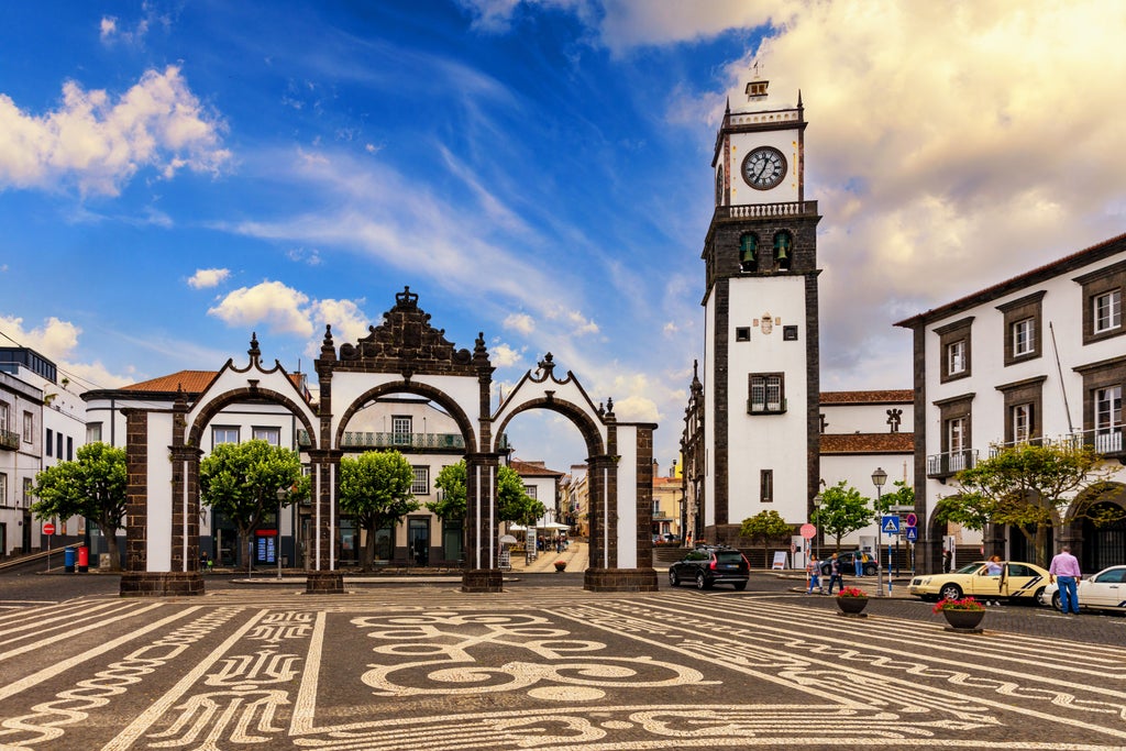 Sunset over Ponta Delgada's historic waterfront, featuring elegant colonial architecture, traditional cobblestone streets, and azure waters of the Azores.