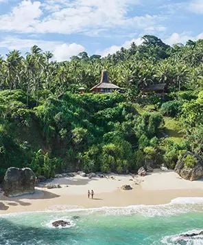 Luxurious beachfront villa at NIHI Sumba resort, overlooking turquoise waters with private infinity pool and lush tropical landscape in Indonesia