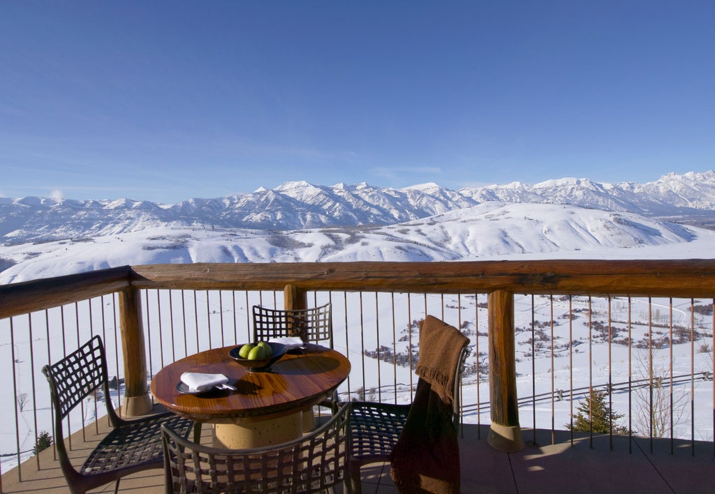 Luxurious mountain resort Amangani nestled in snowy peaks of Wyoming, featuring infinity pool overlooking dramatic valley landscape