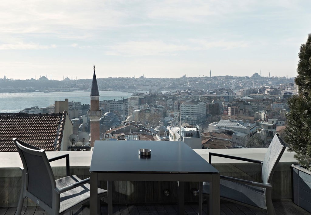 Luxurious boutique hotel in Istanbul, featuring modern architectural design with sleek lines, warm lighting, and elegant contemporary Turkish decor