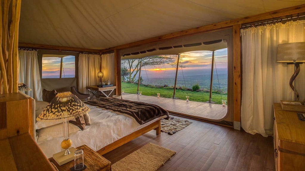 Luxurious tented camp overlooking dramatic Kenyan landscape with canvas-walled suites, expansive wooden decks, and sweeping views of rugged wilderness