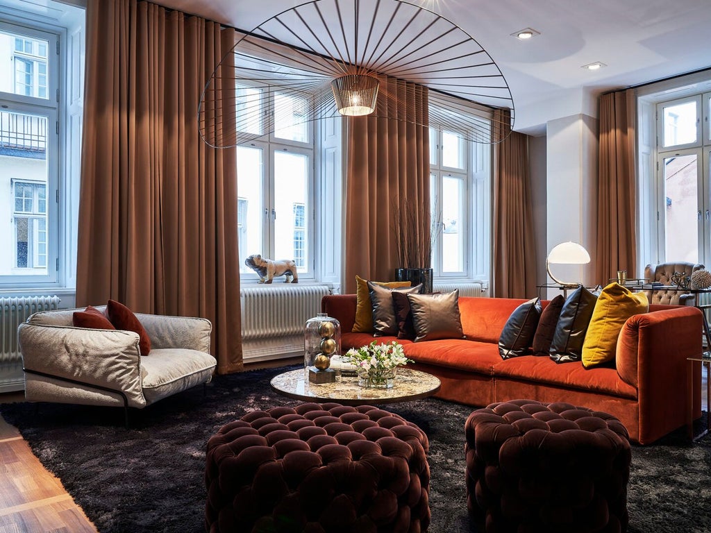 Elegantly designed luxury hotel room in scenset Stockholm, featuring sophisticated neutral tones, designer furniture, and expansive street view window