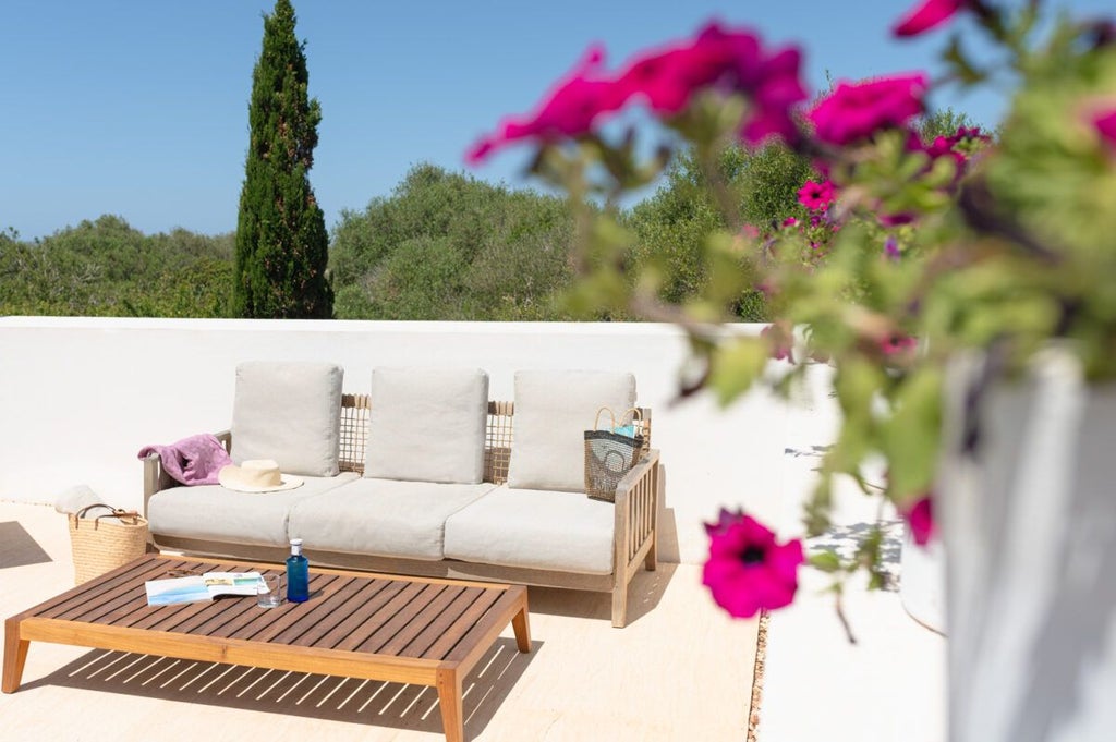 Elegant whitewashed Spanish hotel room with minimalist design, rustic wooden accents, and soft natural light illuminating a tranquil Mediterranean-style interior