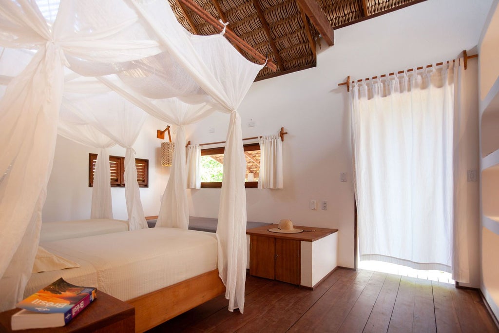 Luxurious garden view room at La Ferme de Georges Park Lodge, featuring rustic wooden furnishings and lush green landscape through large windows