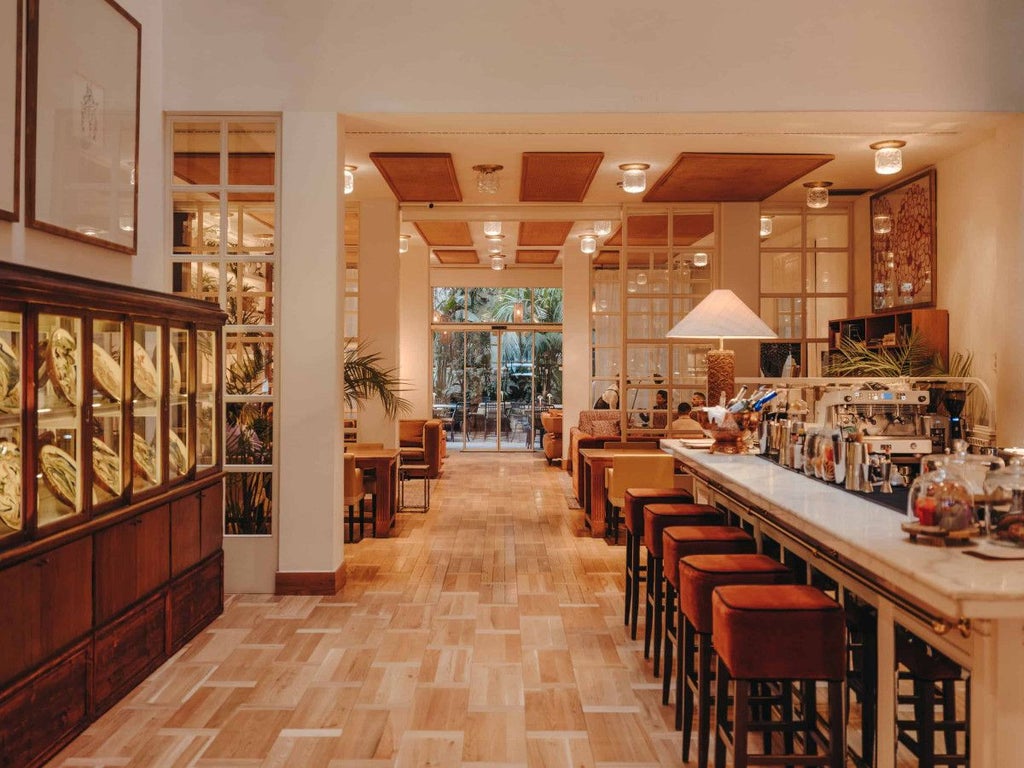 Elegant boutique hotel lobby with Art Nouveau architecture, warm lighting, plush seating, and classic Spanish design in Barcelona's historic center