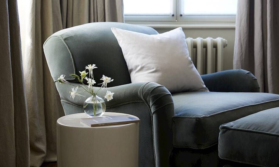 Elegant, muted neutral-toned luxury bedroom with soft linens, minimalist wooden furniture, and panoramic countryside view at Scenset's Heath Room