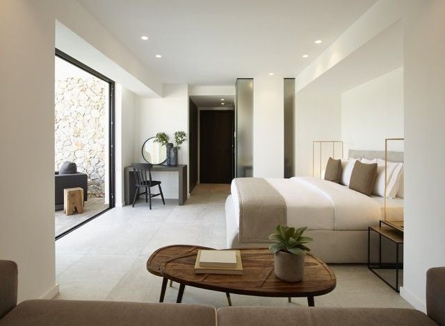 Luxurious superior suite at Scenset Design Hotel & Spa in Greece, featuring a sleek private pool, modern minimalist design, and elegant white interiors.