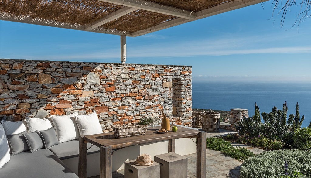 Minimalist white Greek hotel room with panoramic sea view, sleek contemporary design, blue Aegean horizon, and elegant minimalist furniture at Verina Astra.