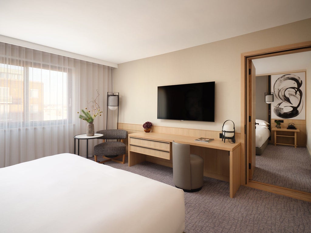 Luxurious Superior Room at Nobu Hotel London Portman Square, featuring elegant design, plush white bedding, and contemporary minimalist décor with warm wood accents