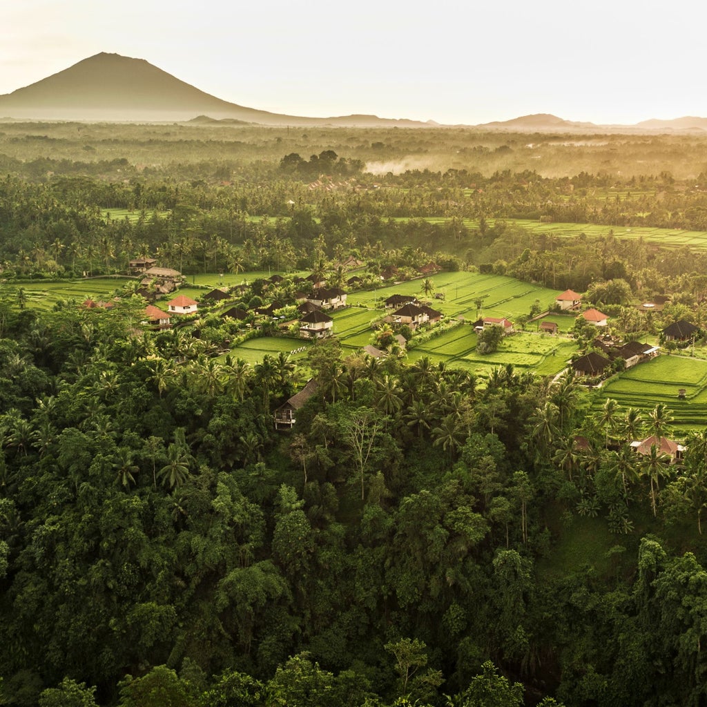 Luxurious COMO Uma resort nestled in lush Ubud jungle, featuring elegant tropical architecture with infinity pool overlooking verdant Balinese landscape