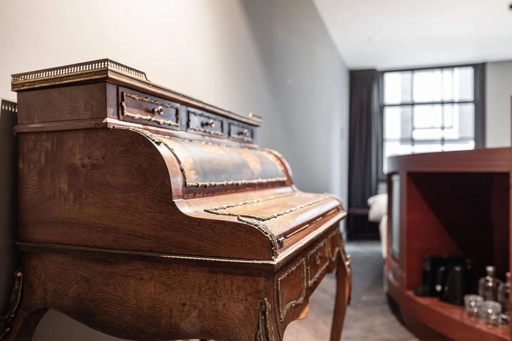 Elegant boutique hotel in Amsterdam with historic Dutch architecture, featuring ornate brick facade and traditional step-gabled roofline