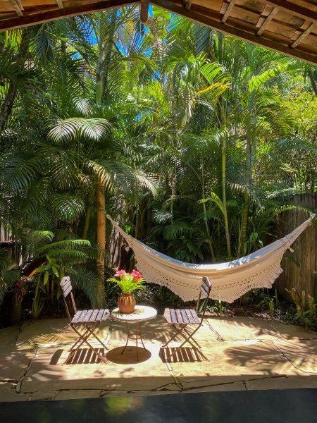 Rustic wooden interior of luxury Brazilian hotel room with traditional design, handcrafted furniture, and warm tropical ambiance at UXUA Casa Hotel and Spa