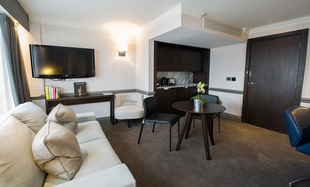 Elegant modern hotel suite at The Scenset Hotel in the United Kingdom, featuring plush white bedding, minimalist design, and contemporary furnishings