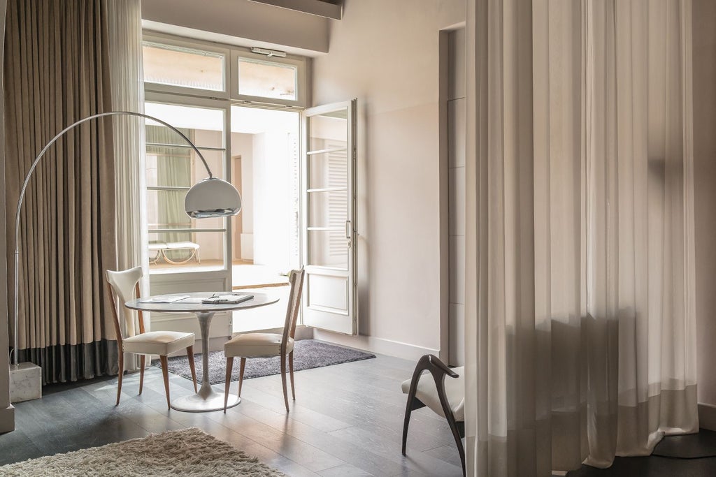 Elegant Italian junior suite with minimalist design, warm wood tones, expansive windows overlooking Tuscan landscape, and modern architectural details