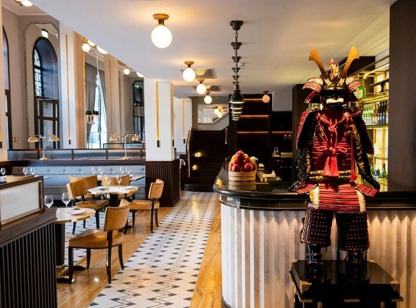 Elegant Art Nouveau facade of Maison Albar luxury hotel, golden details gleaming, Porto's historic charm captured in ornate architectural splendor.