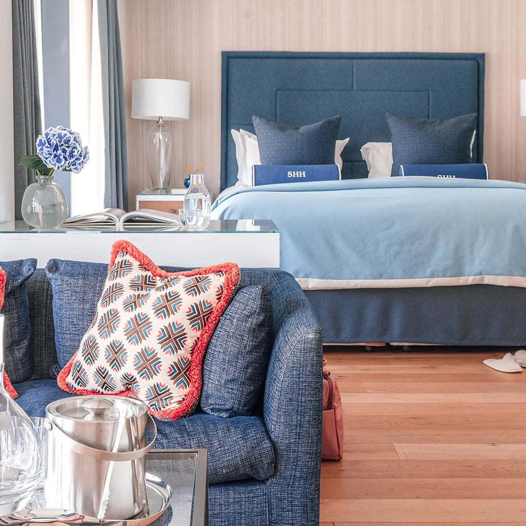 Luxurious Marina View Suite with private balcony overlooking Southampton's harbour, featuring modern decor, floor-to-ceiling windows, and elegant contemporary design