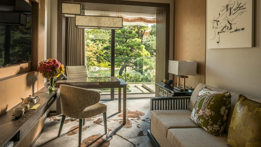 Luxurious Japanese-style suite with traditional shoji screens, elegant dark wood furniture, king bed, and panoramic garden views.