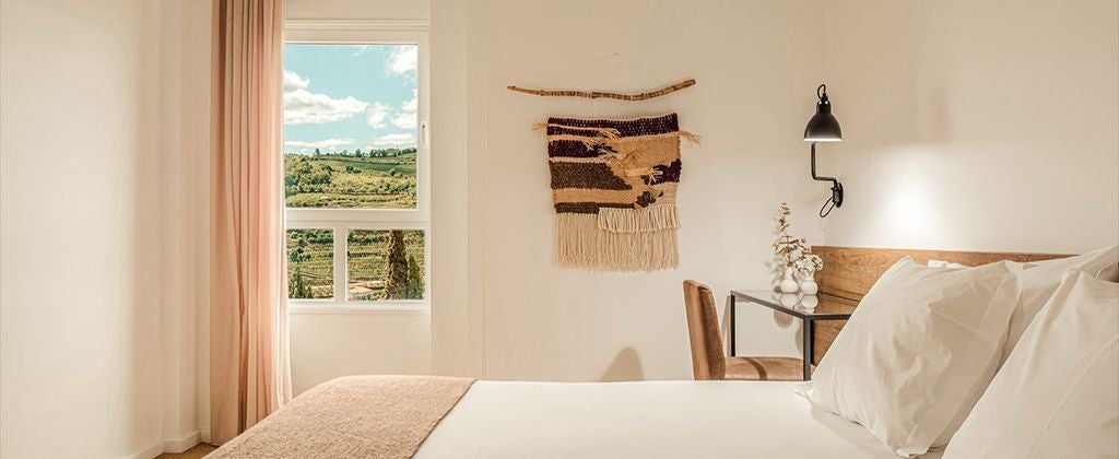 Elegant double room with panoramic valley view, featuring modern decor, plush bedding, and warm wooden accents in the scenic Lamego Hotel & Life, Portugal