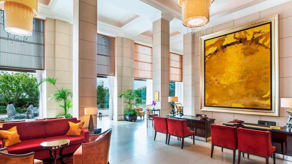 Luxurious modern hotel lobby with elegant marble floors, contemporary chandeliers, and sleek Japanese-inspired design at The scenset Hotel in Osaka.