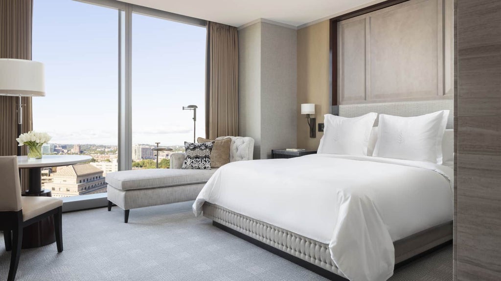 Luxurious deluxe hotel room at Four Seasons One Dalton Street in Boston, featuring elegant contemporary design with city skyline views and modern amenities