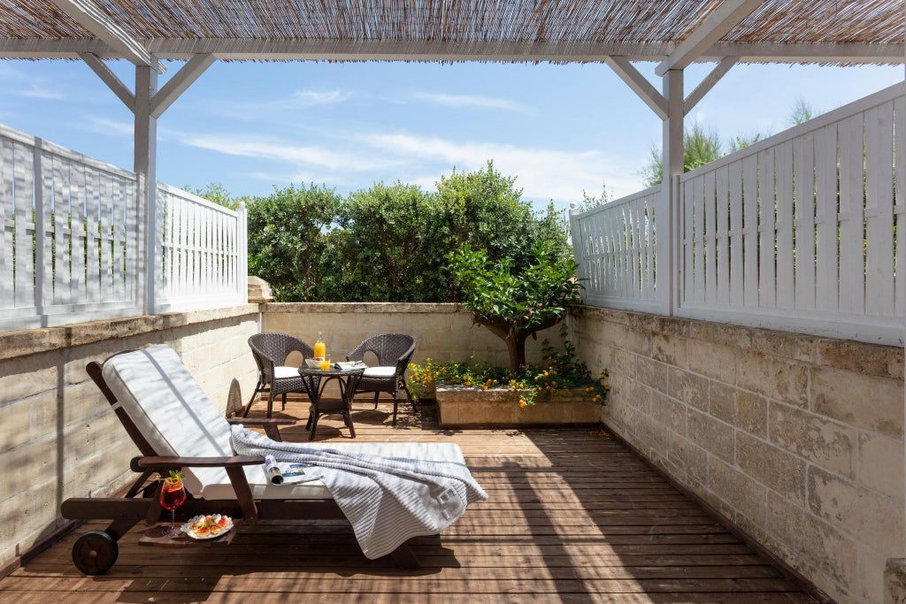 Elegant white-themed classic hotel room with minimalist design, plush bedding, and soft natural light, showcasing refined Italian coastal hospitality