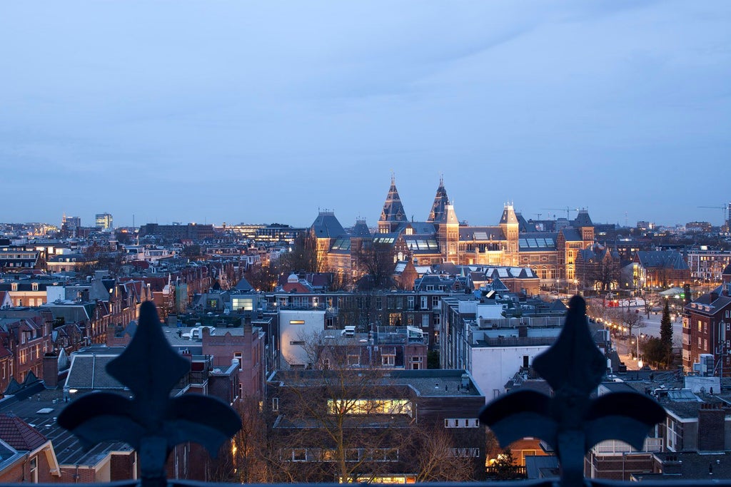 Luxurious glass-fronted Scenset Hotel with modern architectural design, blending historic building and contemporary glass structure in Netherlands