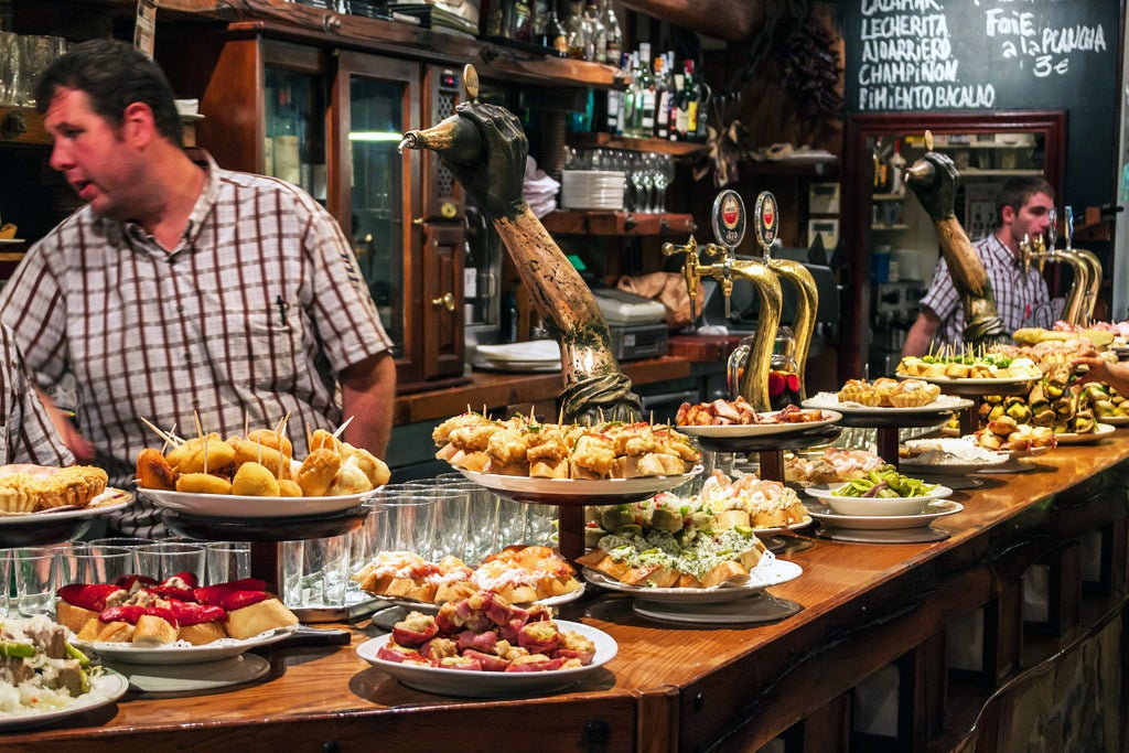 Elegant Basque tapas spread on rustic wooden boards, colorful pintxos artfully arranged with local charcuterie, cheeses, and fresh seafood in San Sebastián