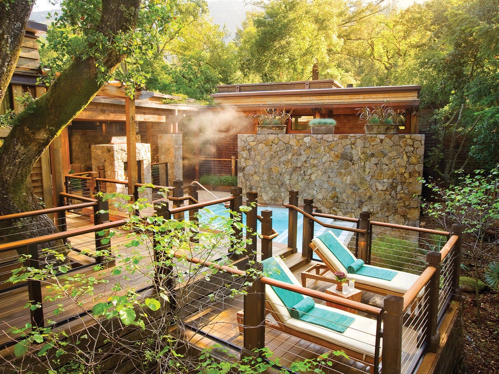 Luxurious mountain resort nestled among towering redwoods, featuring modern wooden cabins with private terraces and natural lake views