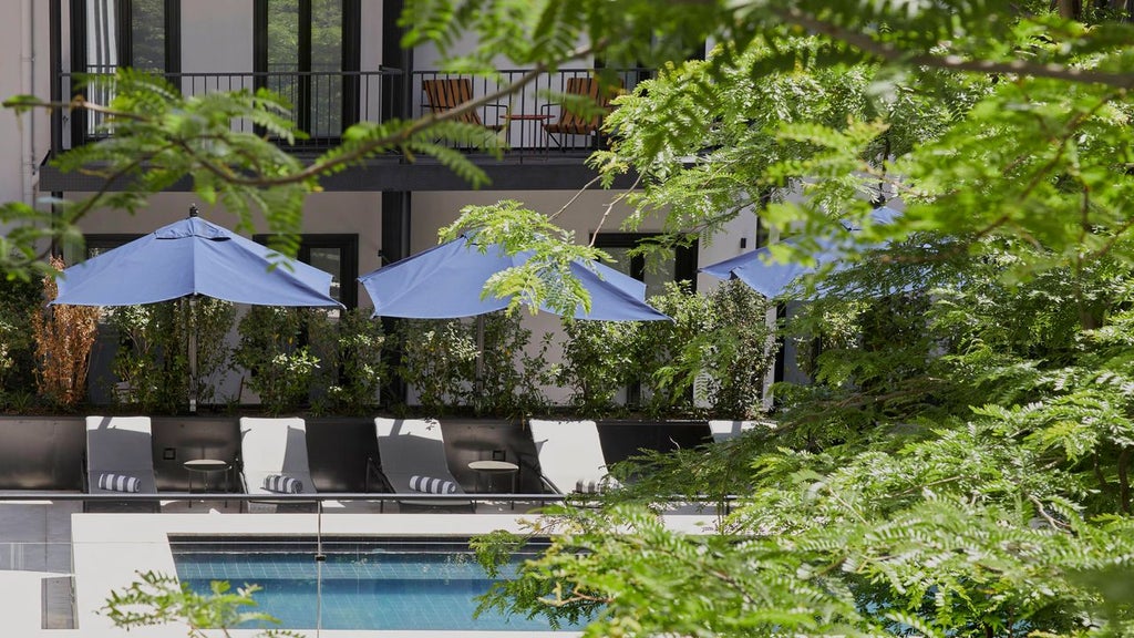 Elegant boutique hotel facade with lush garden, traditional Portuguese architectural details, and warm, inviting exterior lighting at dusk