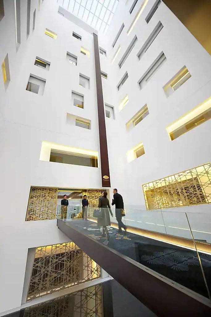 Luxurious Mandarin Oriental Barcelona hotel façade with modern glass-and-steel design, ornate balconies, and ambient evening lighting