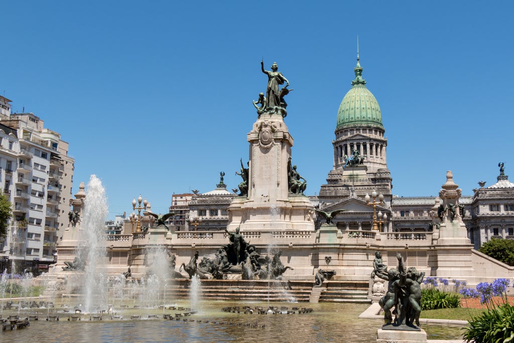 Luxurious evening cityscape of Buenos Aires with illuminated historic buildings, palm-lined streets and elegant colonial architecture