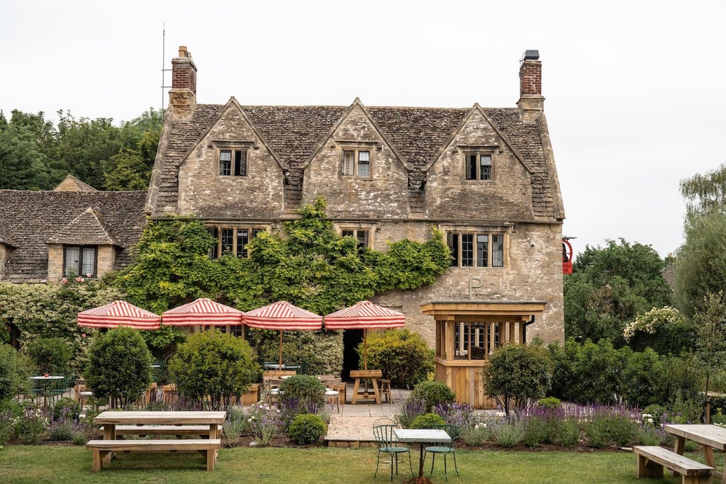 Elegant red-brick facade of Double Red Duke hotel, traditional British architecture with warm lighting and inviting entrance in scenic countryside setting