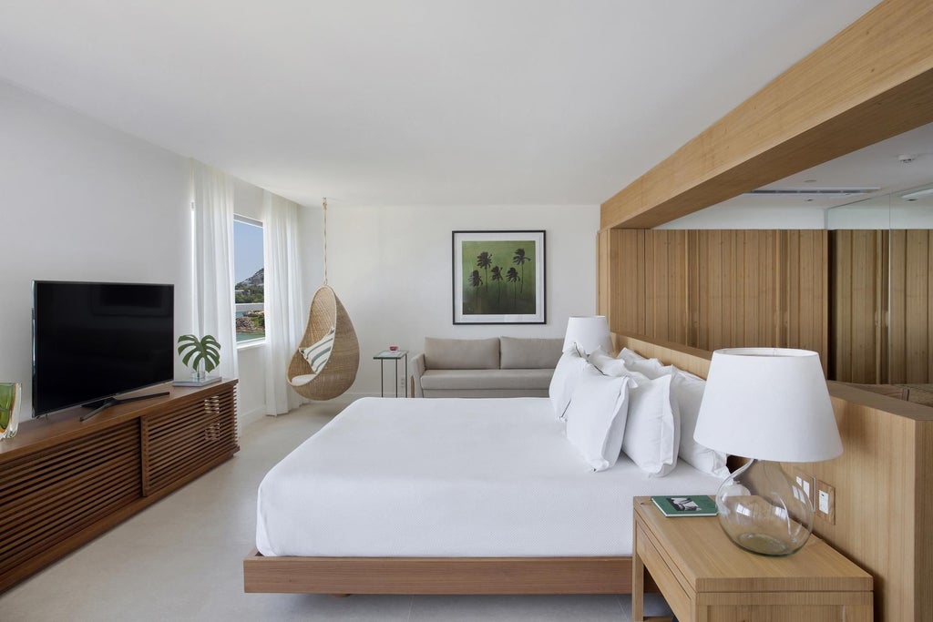 Luxurious Janeiro Hotel suite in Brazil with panoramic ocean view, modern minimalist design, floor-to-ceiling windows, and elegant contemporary furnishings