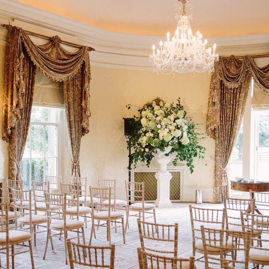 Elegant Edwardian country house hotel with manicured gardens, stone facade, and grand architecture nestled in lush green Wiltshire countryside