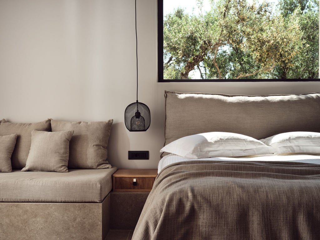 Luxurious Greek villa bedroom with white-draped four-poster bed, panoramic sea view, elegant wooden floors, and minimalist Cycladic design aesthetic