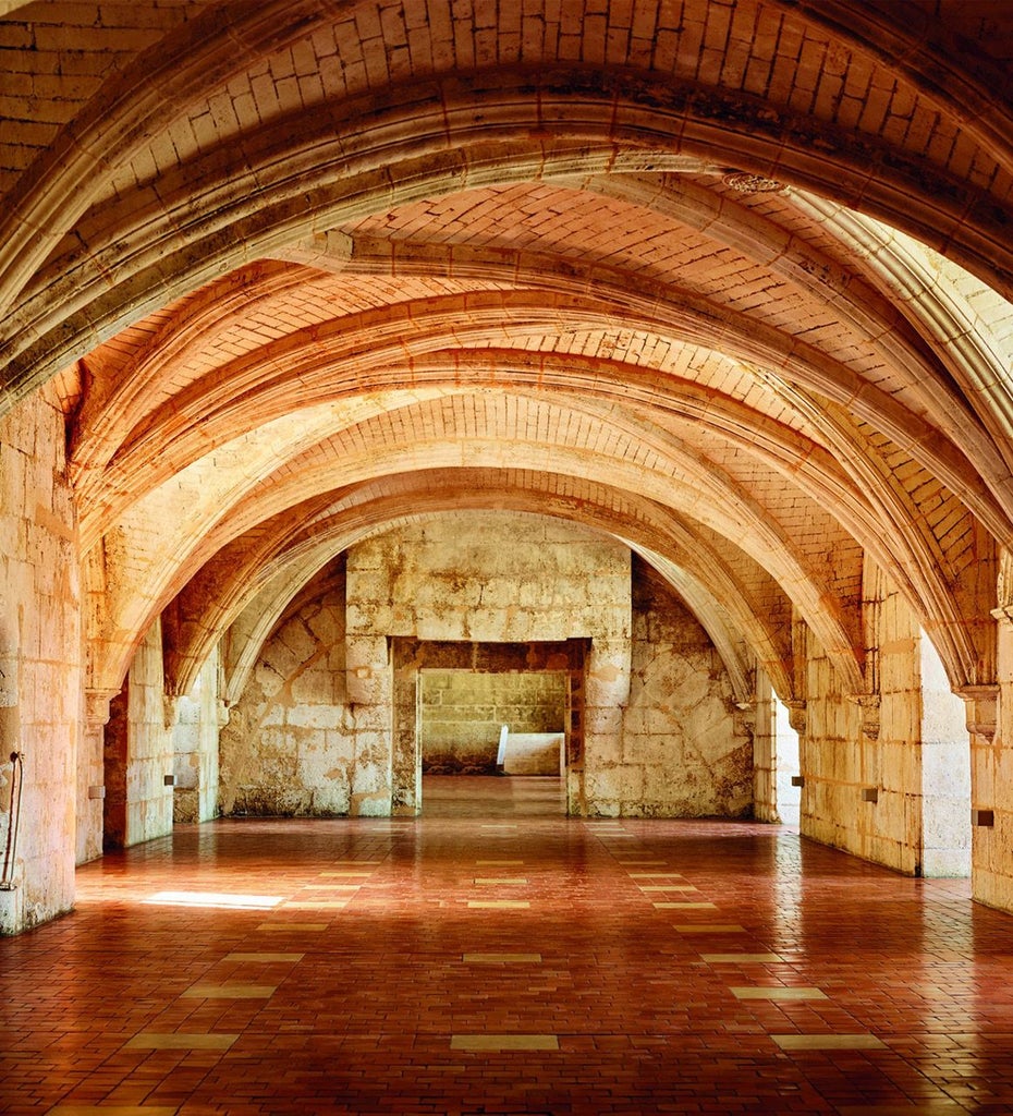 Elegant historic French hotel with stone facade, luxurious spa, and warm lighting, showcasing sophisticated architectural blend of traditional and modern design in Cognac.