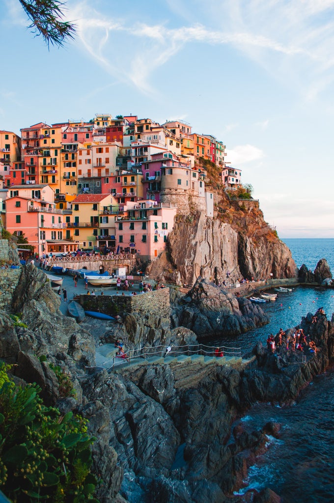 Scenic view of azure Mediterranean waters with dramatic cliffs and colorful hillside houses along Italy's scenic Amalfi Coast