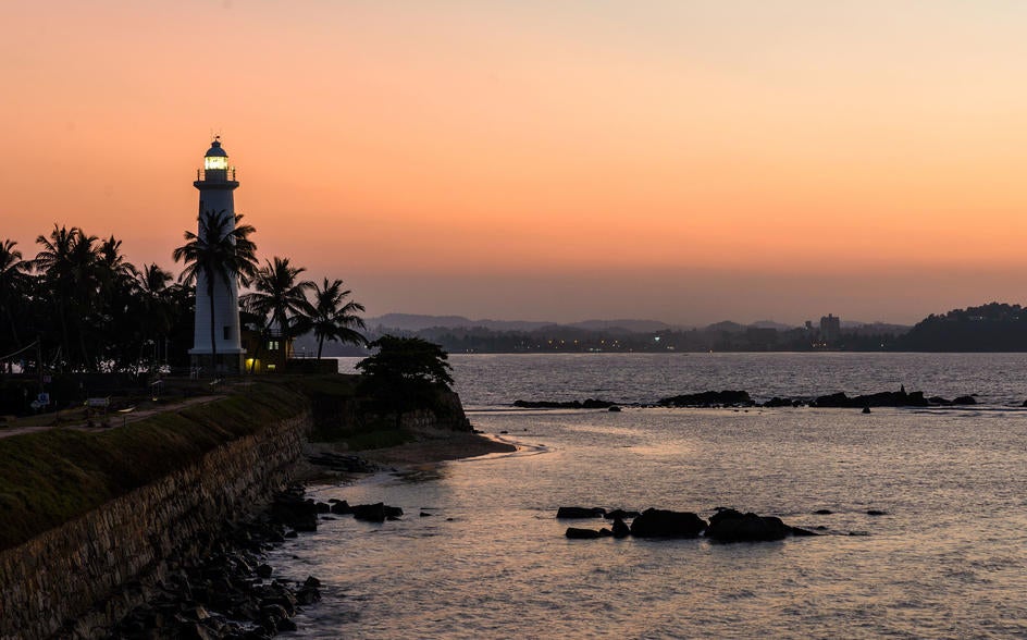 Historic colonial mansion with whitewashed walls, dark wood shutters, and tropical gardens, serving as a luxury boutique hotel in Galle, Sri Lanka