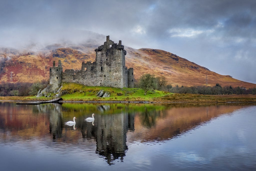 Scenic Highland landscape with misty Glencoe mountains, verdant green valleys, and luxurious Ben Nevis gondola ascending through dramatic Scottish wilderness