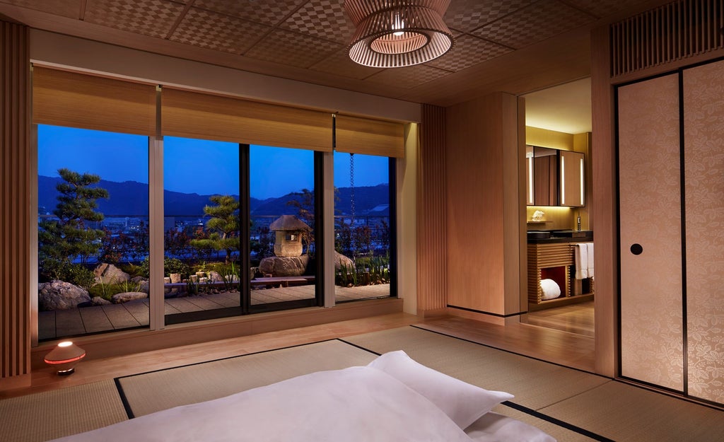 Traditional Japanese garden with stone path winding past manicured trees, facing a modern luxury hotel building with wood accents