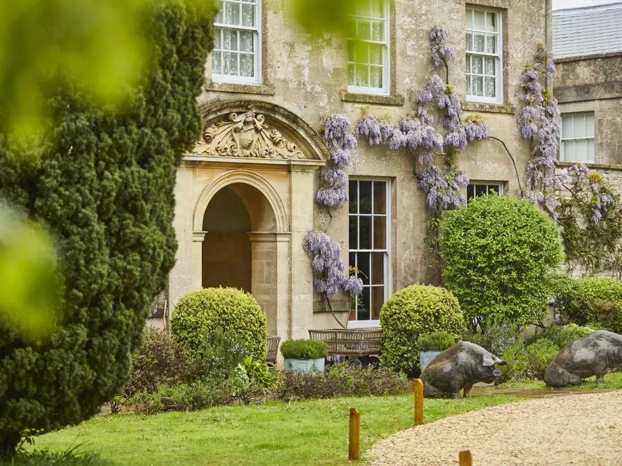 Coastal luxury hotel nestled in lush seaside landscape, featuring rustic-chic architecture with panoramic ocean views and verdant gardens near British shoreline