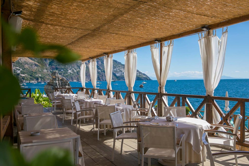 Mediterranean luxury hotel built into Amalfi Coast cliffside with multi-level terraces, private balconies and panoramic sea views