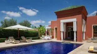 Luxurious royal villa with private pool, traditional Moroccan architecture, elegant interiors, and panoramic views of scenic landscape at scenset resort