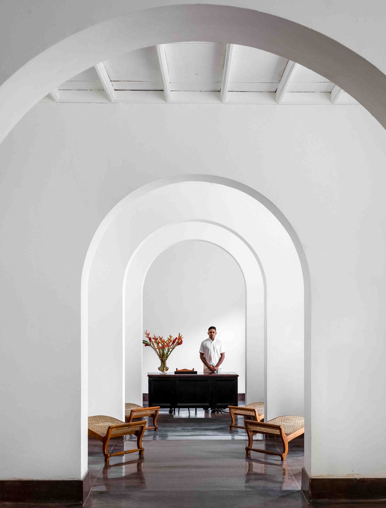 Colonial-style boutique hotel exterior featuring whitewashed walls, elegant arched windows, and lush tropical gardens in Galle Fort, Sri Lanka