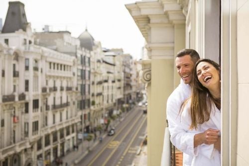 Elegant hotel lobby in Madrid with grand marble columns, plush seating, and sophisticated Spanish architectural details in warm, luxurious tones