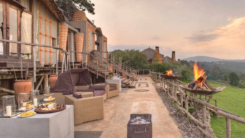 Luxurious thatched-roof lodge perched on Ngorongoro Crater rim with panoramic views of misty African savanna at sunrise